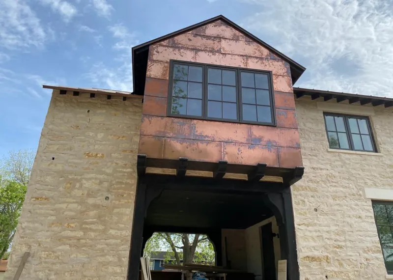 Copper metal panel facade on a stone building for Metal Roof Coating in Compton