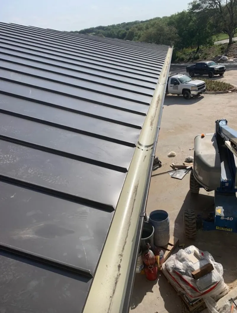 Standing seam panel and gutter detail on a metal roofing jobsite in Compton